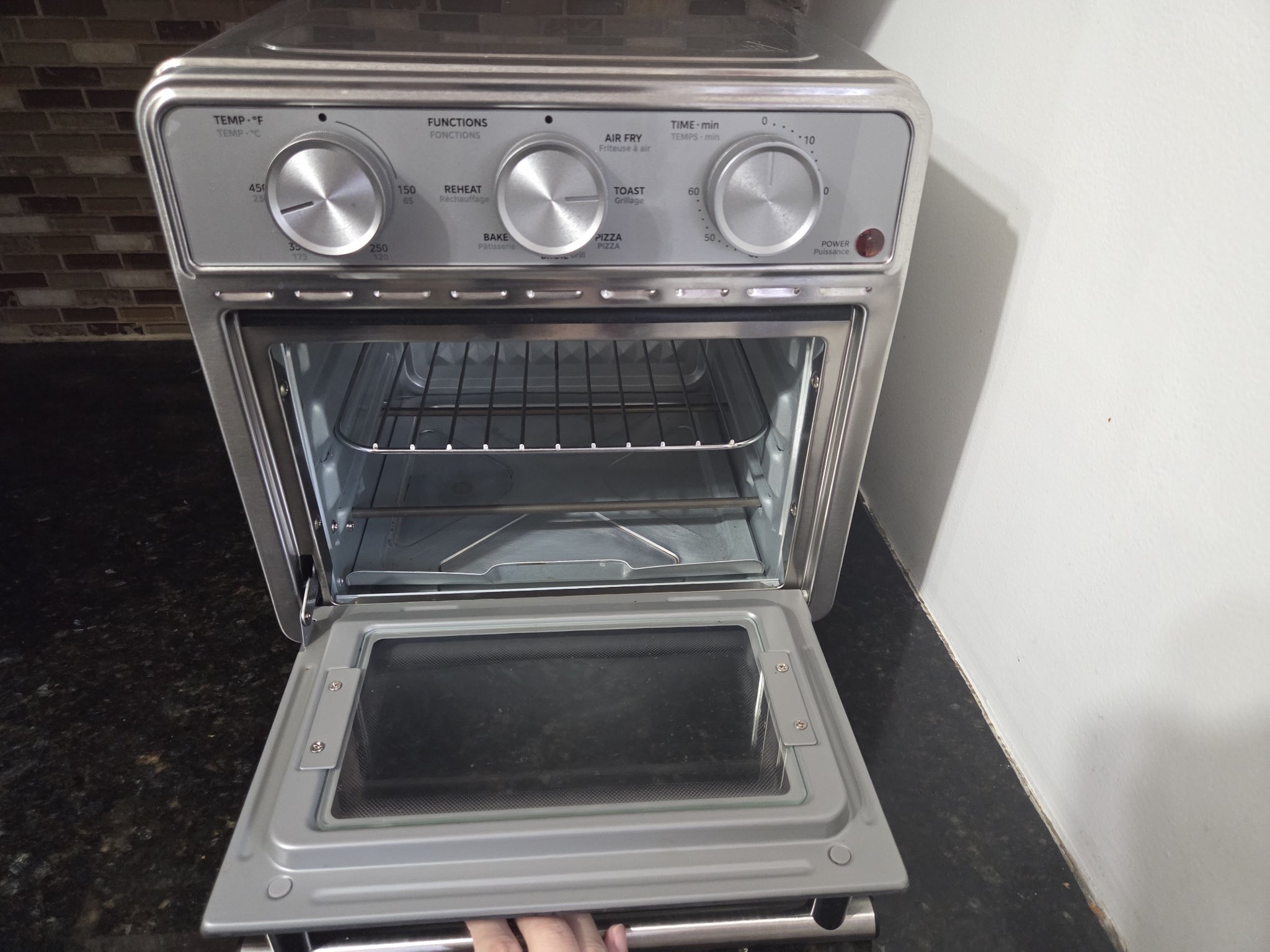 Midea Neo oven with glass door open, showing interior rack