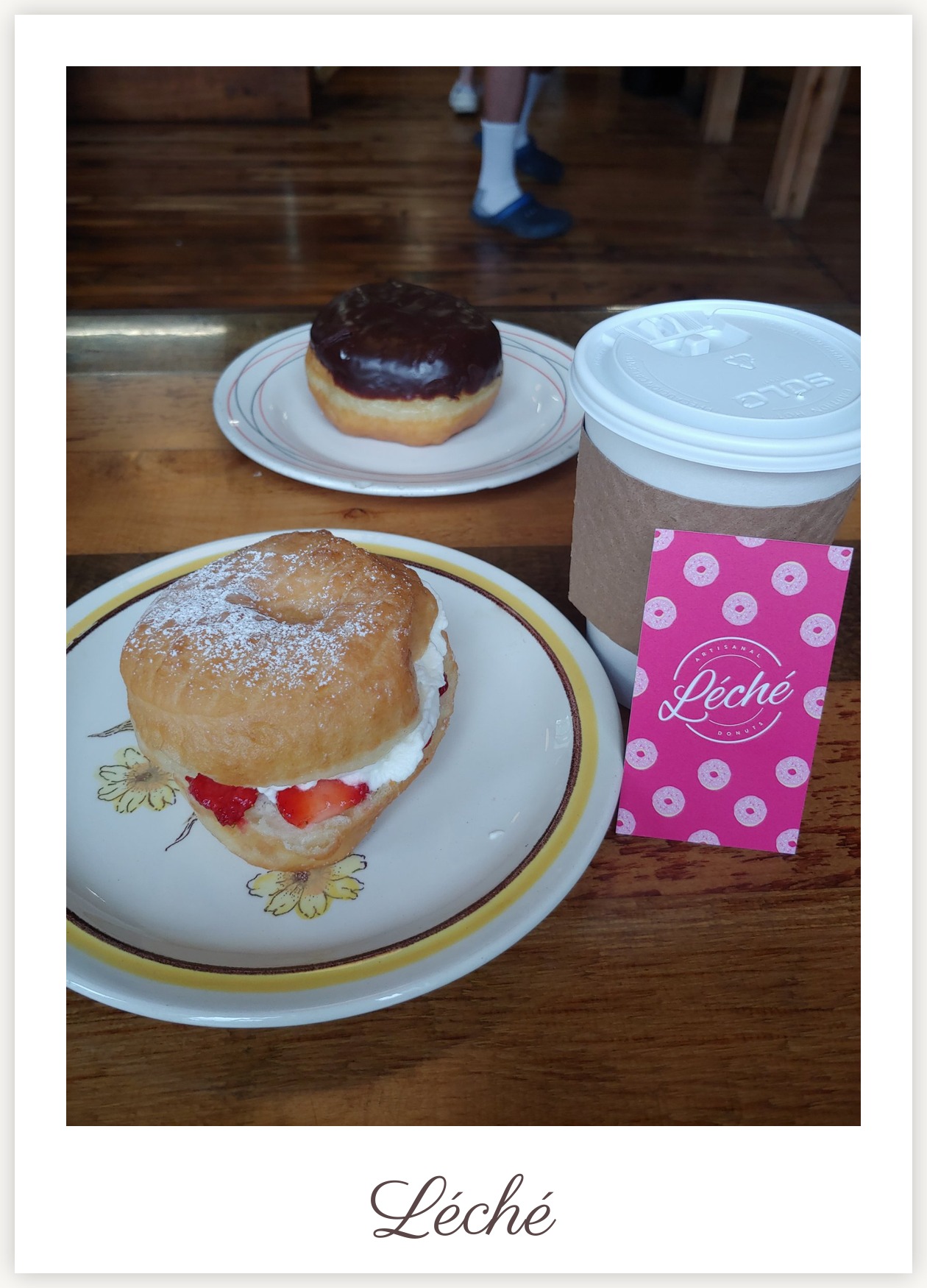 Strawberry cream donut close-up with Léché Desserts business card